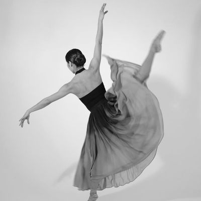 Blurred motion of a person jumping in a studio.