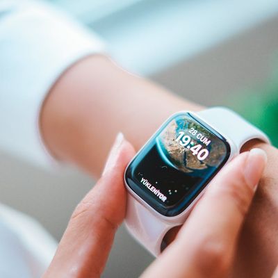 Close up of a person adjusting their fitness watch.